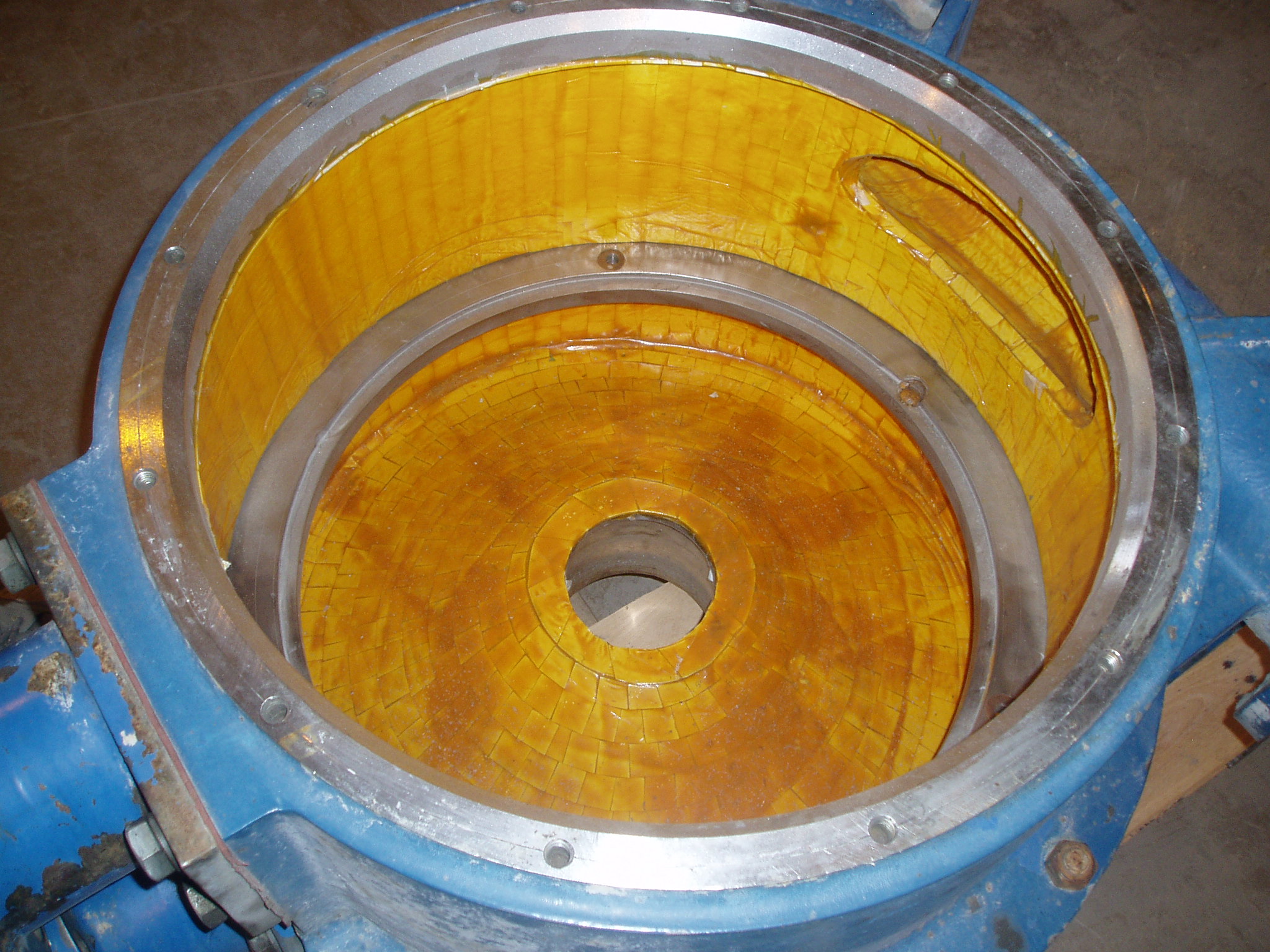 Pump volute with vacuum bonded ceramic tile lining.
